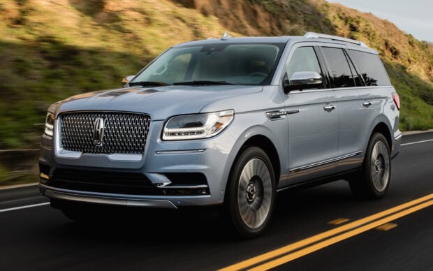 A silver Lincoln luxury SUV is driving on a highway with nature in the background, HD Desktop Wallpaper