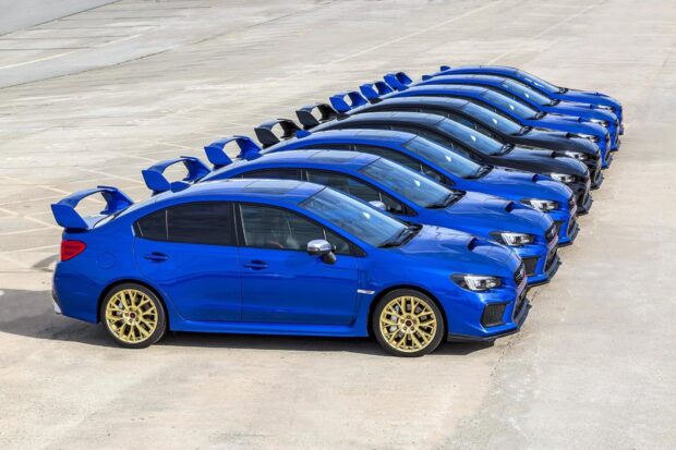 A lineup of Subaru WRX cars is parked outdoors with blue and black colors, HD Desktop Wallpaper