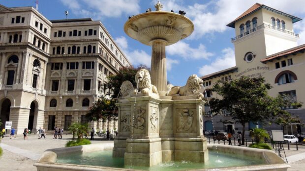 The lion fountain stands prominently in the Havana Cuba city center with historic buildings around, HD Desktop Wallpaper