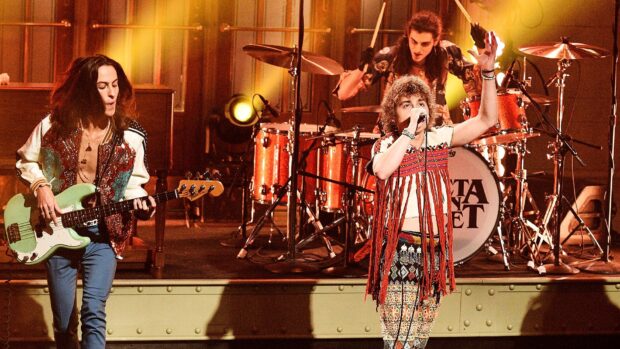 The hard rock band performs energetically on stage with instruments, HD Desktop Wallpaper