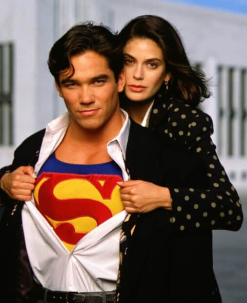 A man reveals his Superman suit while a woman stands behind him in a protective pose, HD Mobile Wallpaper