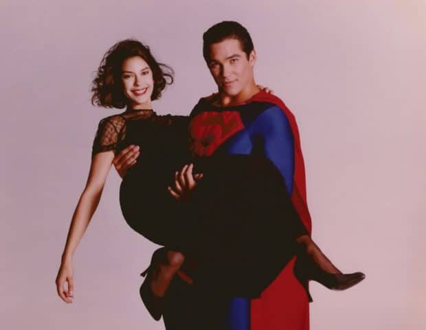 A man dressed as Superman is holding a smiling woman in a black dress, HD Desktop Wallpaper