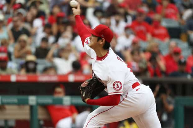A Los Angeles Angels player is pitching the baseball during the game in front of a crowded stadium, 2K Desktop Wallpaper
