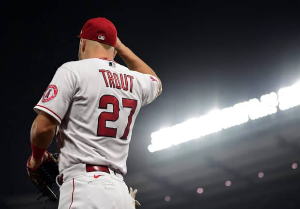 A Los Angeles Angels player in a white uniform catches the ball under stadium lights during a game, 2K Desktop Wallpaper