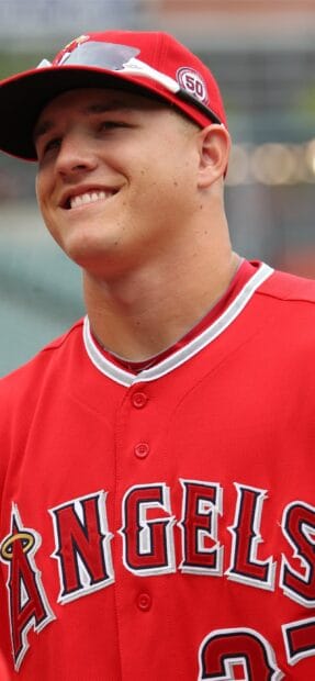A smiling Los Angeles Angels player wearing a red uniform and cap, 2K Phone Wallpaper