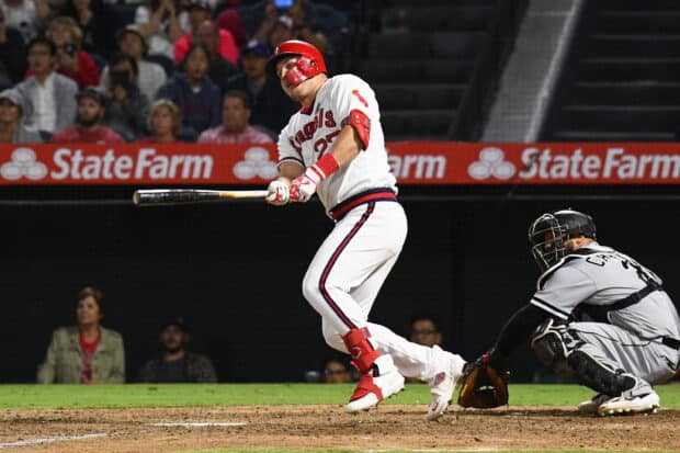 A Los Angeles Angels player swings a bat during the game with a catcher behind him, 2K Desktop Wallpaper