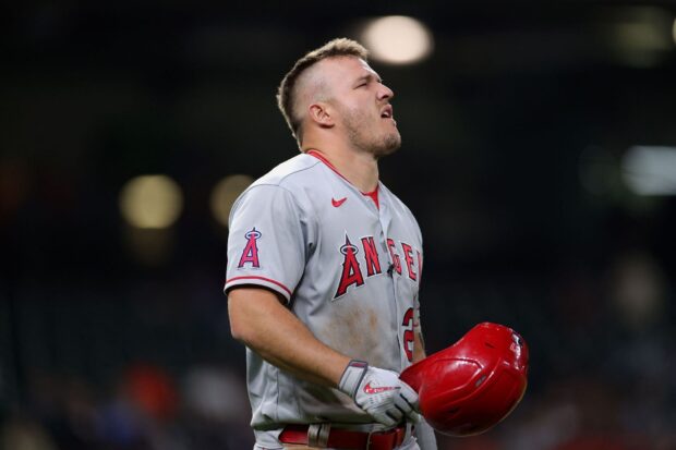 A Los Angeles Angels player holds his red helmet during the game, HD Desktop Wallpaper
