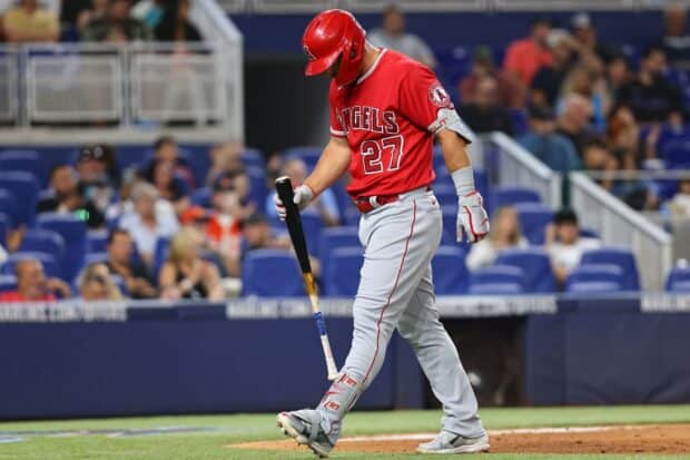 A Los Angeles Angels player in red uniform is standing with a bat during a game, HD Desktop Wallpaper