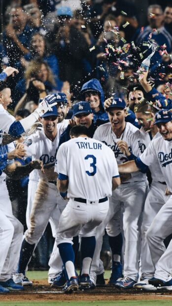 The Los Angeles Dodgers team celebrates a player's home run with confetti and excitement, HD Phone Wallpaper
