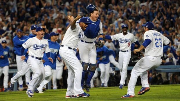 Los Angeles Dodgers players celebrate a major win on the baseball field with fans cheering, HD Desktop Wallpaper