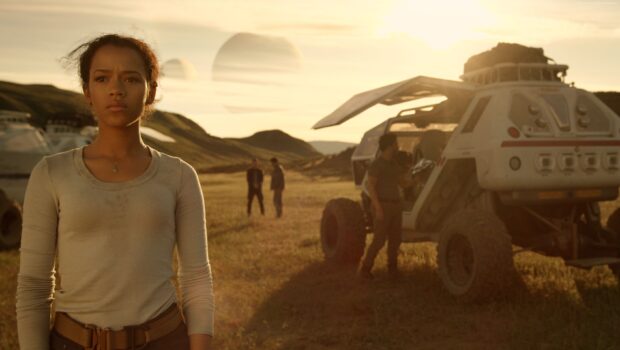 A woman stands determined next to futuristic vehicle in Lost In Space Tv Series, 2K Desktop Wallpaper