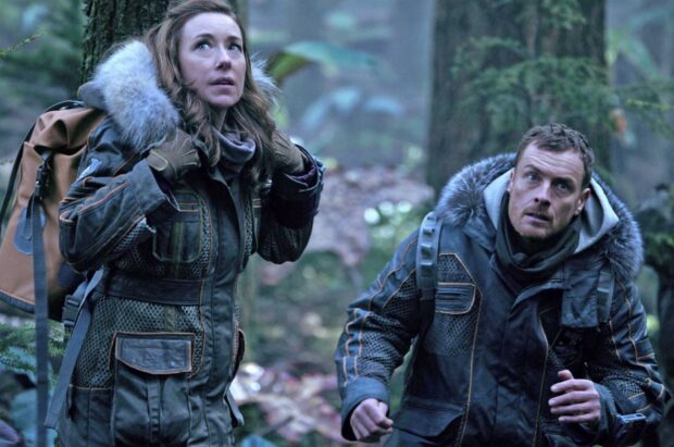 Two Lost In Space tv series characters explore a dense forest in survival gear, HD Desktop Wallpaper