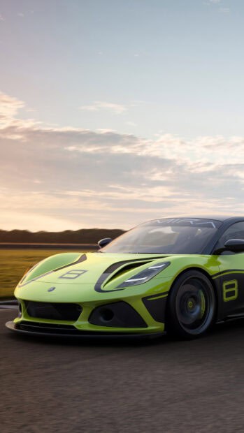 A green Lotus Emira is speeding on the track during sunset with a cloudy sky, 4K Mobile Wallpaper