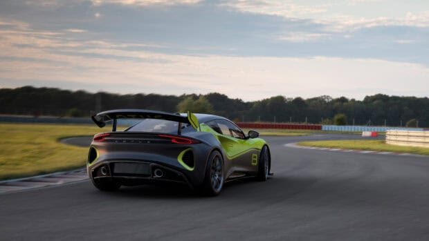 A Lotus Emira is speeding on a race track with a scenic background, 4K Desktop Wallpaper