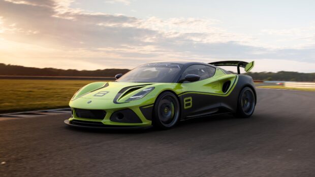 A green and black Lotus Emira racing car is speeding on a race track during sunset, 4K Desktop Wallpaper