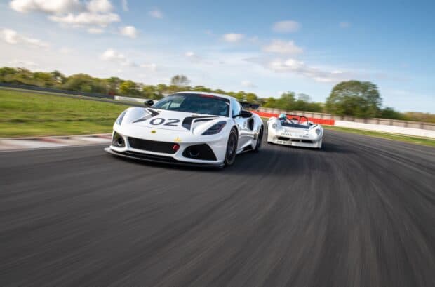 Two Lotus Emira models competing on a race track with motion blur, 2K Desktop Wallpaper
