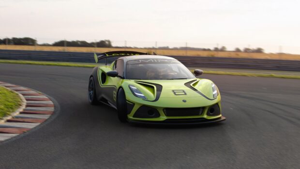 A bright green Lotus Emira races around a curved track on a clear day, 4K Desktop Wallpaper
