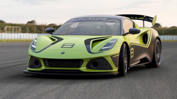 A green Lotus Emira sports car is driving on a racetrack during the day, HD Desktop Wallpaper