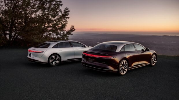 Two Lucid Motors vehicles are parked on a hill with a sunset backdrop, HD Desktop Wallpaper