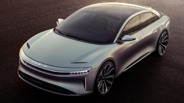 A sleek silver Lucid Motors car is parked on an asphalt surface during sunset, 4K Desktop Wallpaper