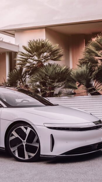 A sleek white Lucid Motors car is parked in front of palm trees and a modern house, 4K Mobile Wallpaper
