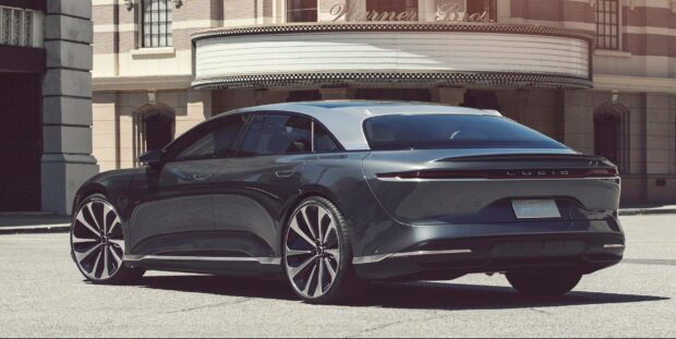 A sleek Lucid Motors electric sedan parked in front of a classic building during daytime, HD Desktop Wallpaper