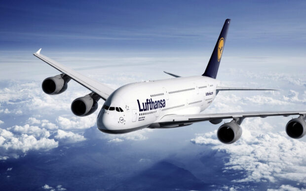 A Lufthansa Airbus A380 soars through the sky over white clouds during flight, HD Desktop Wallpaper