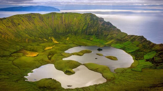 A scenic view of The Azores showing a green crater lake surrounded by hills and ocean, HD Desktop Wallpaper