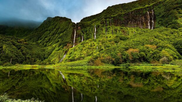 The Azores feature lush green mountains with cascading waterfalls reflected in the lake, HD Desktop Wallpaper