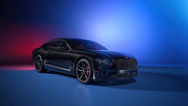 A luxury Bentley Continental GT is showcased under dynamic red and blue lighting, 2K Desktop Wallpaper