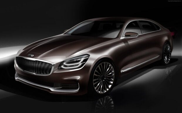 The image shows a sleek luxury Kia sedan with modern headlights and a shiny body, 2K Desktop Wallpaper