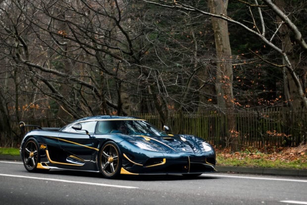 A luxury Koenigsegg car is parked on a quiet tree lined street, 2K Desktop Wallpaper
