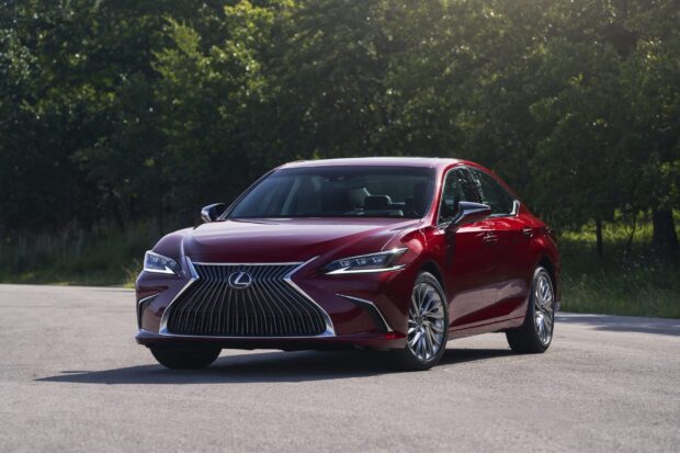 A red Lexus Es car parked on a road with trees in the background, 2K Desktop Wallpaper