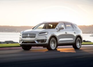 A silver Lincoln car is driving along the waterfront road at sunset in this Lincoln car wallpaper, 4K Desktop Wallpaper