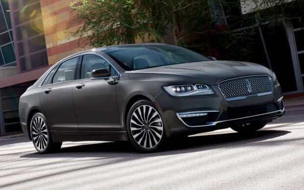 A sleek Lincoln car parked near a building with trees in the background, HD Desktop Wallpaper