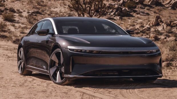 A sleek black Lucid Motors car is parked on a desert road under clear skies, HD Desktop Wallpaper