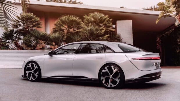 A sleek white Lucid Motors car parked with tropical plants behind, 2K Desktop Wallpaper