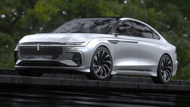 A silver Lincoln car with a sleek modern design is parked near greenery, 2K Desktop Wallpaper
