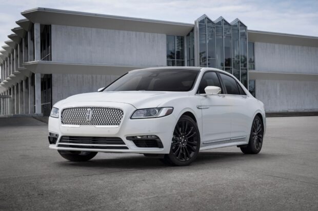 A white Lincoln car is parked on a concrete surface near a glass and concrete building, HD Desktop Wallpaper