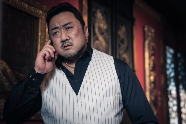 Ma Dong Seok on the phone with a serious expression in a formal outfit, 2K Desktop Wallpaper