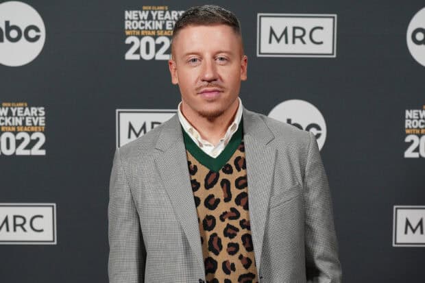 Macklemore stands confidently wearing a leopard print vest and blazer at an event, HD Desktop Wallpaper