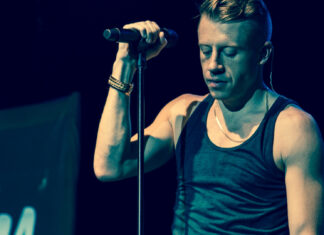 Macklemore is singing into a microphone during a concert, HD Desktop Wallpaper
