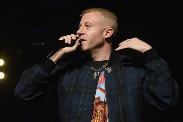 Macklemore is singing with a microphone in hand during a live show, HD Desktop Wallpaper