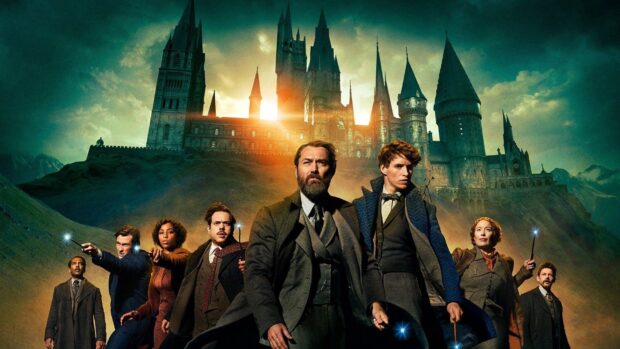 A group of people holding wands with a castle glowing behind in Warner Bros Wallpapers, HD Desktop Wallpaper