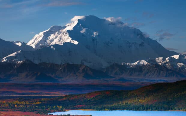 The snowy Denali mountain rises above colorful forests and a lake in Denali National Park, 2K Desktop Wallpaper