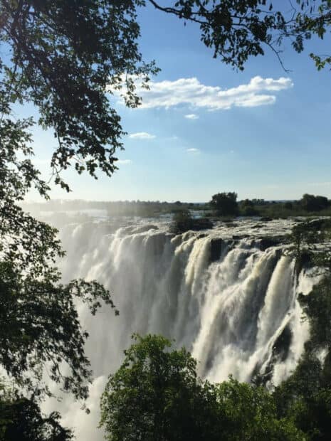The Devils Pool Zambia captures a powerful waterfall surrounded by lush greenery and a clear sky, HD Mobile Wallpaper