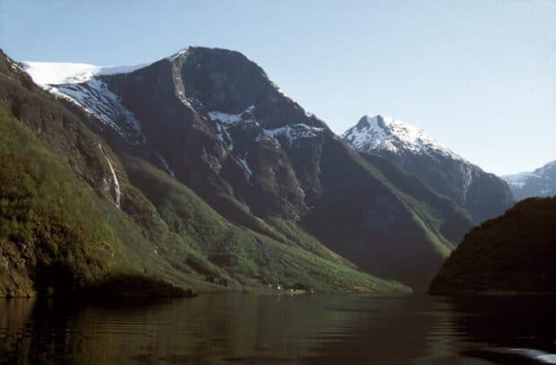 The Norwegian fjords show dramatic cliffs and calm waters under a clear sky, HD Desktop Wallpaper