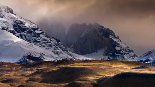 Snowy Mountain Landscape in Torres Del Paine National Park with golden grassy hills and cloudy sky, 4K Desktop Wallpaper