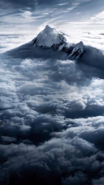 A towering peak rises above the clouds in the Tibetan highlands, 2K Mobile Wallpaper