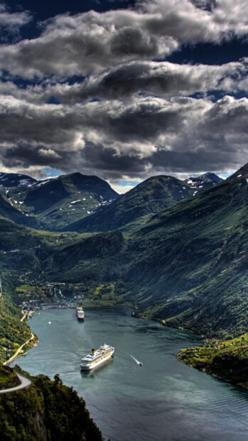 A ferry sails calmly through a scenic fjord surrounded by green mountains, HD Phone Wallpaper